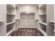 Spacious walk-in closet with built-in shelves and hanging rods at 16019 W Avenida Del Sol --, Surprise, AZ 85387