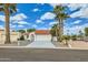 White stucco house with red tile roof, two palm trees, and a driveway at 17030 E Calaveras Ave, Fountain Hills, AZ 85268