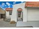 Front entry with arched gate and white stucco walls at 17030 E Calaveras Ave, Fountain Hills, AZ 85268