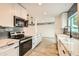 Modern kitchen with white cabinets, quartz countertops and stainless steel appliances at 17030 E Calaveras Ave, Fountain Hills, AZ 85268