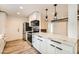 Sleek kitchen with white cabinets, quartz countertops, and stainless steel appliances at 17030 E Calaveras Ave, Fountain Hills, AZ 85268