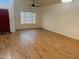 Spacious living area showcasing hardwood floors and a large window at 1722 W Brooks St, Chandler, AZ 85224