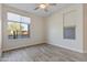 Bright bedroom with wood-look tile floors and large windows offering plenty of natural light at 17527 E Silver Sage Ln, Rio Verde, AZ 85263