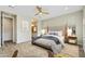 This bedroom features neutral walls, a ceiling fan, and a bathroom visible through an open door at 17527 E Silver Sage Ln, Rio Verde, AZ 85263