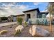 Well-maintained front yard features desert landscaping with rocks, cacti, and mature plants accenting the property at 17527 E Silver Sage Ln, Rio Verde, AZ 85263