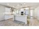 This kitchen features an island with white cabinets, stainless steel appliances, and modern pendant lighting at 17527 E Silver Sage Ln, Rio Verde, AZ 85263