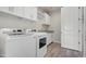 Well-equipped laundry room with modern washer and dryer, ample cabinetry, and countertop space at 17527 E Silver Sage Ln, Rio Verde, AZ 85263