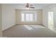 Well-lit bedroom featuring a bay window and ceiling fan at 1861 E Birch St, Casa Grande, AZ 85122