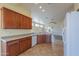 View of kitchen with wood cabinets, granite counters, and tile floors at 1861 E Birch St, Casa Grande, AZ 85122