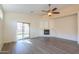 Living room with fireplace, laminate floors, and access to backyard at 1861 E Birch St, Casa Grande, AZ 85122