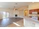 Open living room and kitchen with a fireplace and laminate floors at 1861 E Birch St, Casa Grande, AZ 85122