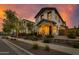 Two-story home with landscaped yard and charming front porch at sunset at 1926 W Lariat Ln, Phoenix, AZ 85085