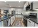 Stylish kitchen with dark countertops, stainless steel appliances, and a gas range at 1926 W Lariat Ln, Phoenix, AZ 85085