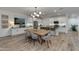 Modern kitchen with white cabinets, a large island, and wooden dining table at 1926 W Lariat Ln, Phoenix, AZ 85085