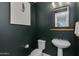 Dark-green powder room with pedestal sink and modern decor at 1926 W Lariat Ln, Phoenix, AZ 85085