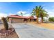 Front yard with driveway, landscaping, and palm trees at 19606 N Trail Ridge Dr, Sun City West, AZ 85375