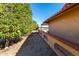 Landscaped side yard with gravel and mature trees alongside the home at 19606 N Trail Ridge Dr, Sun City West, AZ 85375