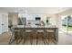 Modern kitchen with white cabinets, center island and sliding glass door at 2003 E Magdalena Dr, Tempe, AZ 85283