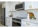 Stylish kitchen with white cabinets, quartz countertops and gold accents at 2003 E Magdalena Dr, Tempe, AZ 85283