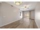 Spacious living room featuring wood-look floors and a ceiling fan at 205 N 74Th St # 122, Mesa, AZ 85207