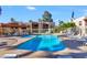 Community pool and spa with lounge chairs and covered patio at 205 N 74Th St # 122, Mesa, AZ 85207