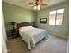Cozy bedroom with carpet, ceiling fan, and queen-sized bed with decorative lamps at 21280 N 262Nd Dr, Buckeye, AZ 85396