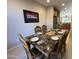 Formal dining room with a marble table, seating for six and desert art on the wall at 21280 N 262Nd Dr, Buckeye, AZ 85396