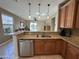 Open kitchen layout featuring granite countertops and stainless steel dishwasher at 21280 N 262Nd Dr, Buckeye, AZ 85396