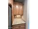 Kitchen area featuring granite countertops and wooden cabinetry at 21280 N 262Nd Dr, Buckeye, AZ 85396