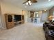 Bright living room featuring tile floors, a ceiling fan, and natural light at 21280 N 262Nd Dr, Buckeye, AZ 85396