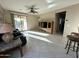 Open concept living room featuring tile flooring and access to an outdoor patio at 21280 N 262Nd Dr, Buckeye, AZ 85396