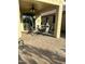 Covered patio with pavers, ceiling fan, and outdoor dining set perfect for entertaining at 21280 N 262Nd Dr, Buckeye, AZ 85396
