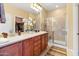 Double vanity bathroom with large shower and walk-in closet at 21280 N 262Nd Dr, Buckeye, AZ 85396