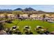 Expansive lawn with cornhole and seating; scenic mountain backdrop at 21280 N 262Nd Dr, Buckeye, AZ 85396