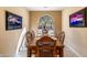 Bright dining room with a charming table and chairs, offering views of the backyard at 21280 N 262Nd Dr, Buckeye, AZ 85396