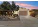 Charming house with desert landscaping at dusk at 21280 N 262Nd Dr, Buckeye, AZ 85396