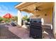 Outdoor patio with built-in grill and seating area at 21280 N 262Nd Dr, Buckeye, AZ 85396