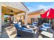 Relaxing backyard patio with fire pit, seating area, and built-in grill at 21280 N 262Nd Dr, Buckeye, AZ 85396