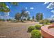 Landscaped backyard with gravel and green bushes at 21413 N 159Th Dr, Sun City West, AZ 85375