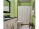 Bathroom with a shower/tub combo, white vanity, and black countertop at 21413 N 159Th Dr, Sun City West, AZ 85375