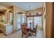 Bright breakfast nook with wooden table and chairs, offering access to a patio at 21413 N 159Th Dr, Sun City West, AZ 85375