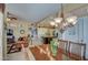 Spacious dining area with wooden table and chandelier, adjacent to kitchen and living room at 21413 N 159Th Dr, Sun City West, AZ 85375