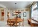 Elegant dining room features a large table, chandelier, and built-in hutch at 21413 N 159Th Dr, Sun City West, AZ 85375