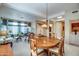 Open concept dining room with a large table, and views into living room and entryway at 21413 N 159Th Dr, Sun City West, AZ 85375