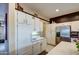 White kitchen with stainless steel appliances and island at 21413 N 159Th Dr, Sun City West, AZ 85375