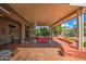 Spacious covered patio with comfortable seating and outdoor lighting at 21413 N 159Th Dr, Sun City West, AZ 85375