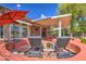 Patio with comfortable lounge chairs and red umbrella at 21413 N 159Th Dr, Sun City West, AZ 85375