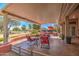 Covered patio with comfortable seating overlooking the golf course at 21413 N 159Th Dr, Sun City West, AZ 85375