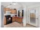 Kitchen boasts wood cabinets, stainless steel appliances, and red countertops at 21543 W Church Ave, Wittmann, AZ 85361