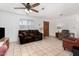 Bright living room with tile floors, comfortable seating, and ceiling fan at 21543 W Church Ave, Wittmann, AZ 85361